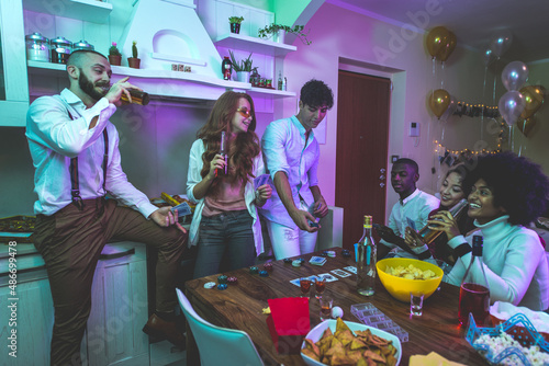 Картината върху платно A group of young people celebrating and making party at home