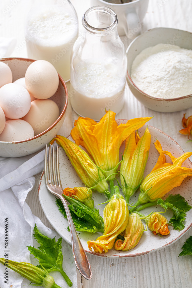 Preparation for roasted pumpkin flower as a seasonal summer snack. Preparation for roasted pumpkin flower as a seasonal summer snack.