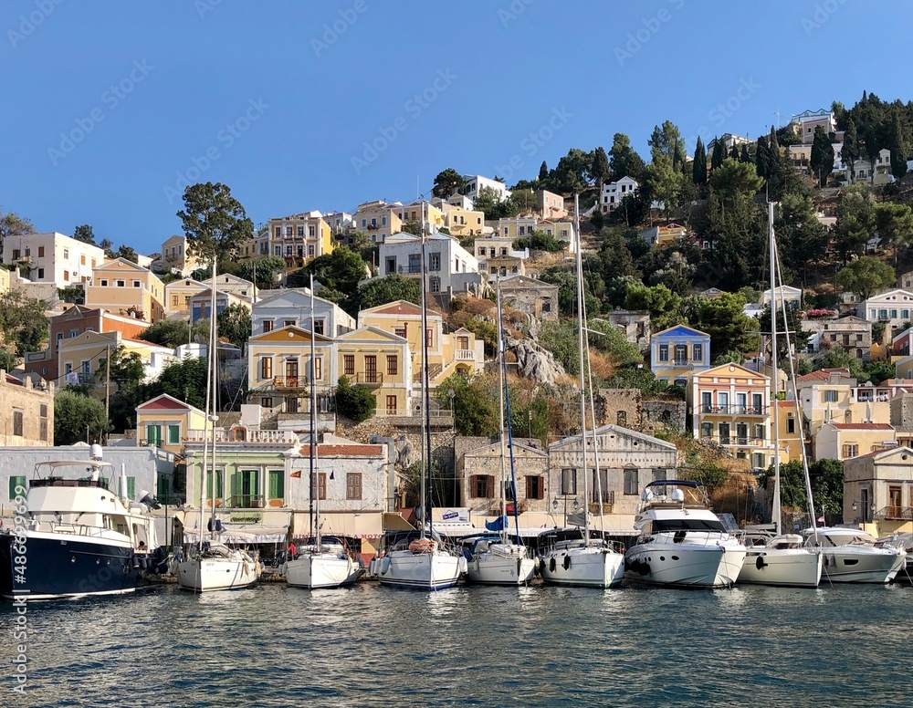 Symi island view from the sea. Aegean Sea. Marina, yachts, colourful houses, mountain. Boats in the harbor. Greece. Dodecanese islands 