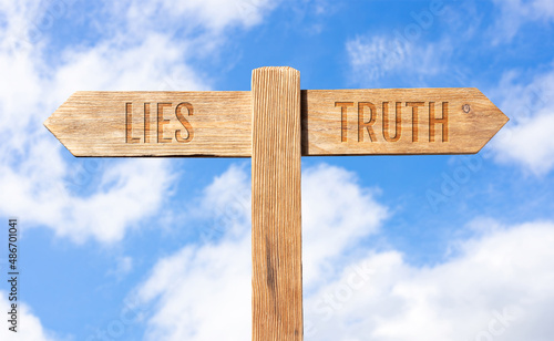 Lies or Truth concept. Wooden signpost with message on sky background