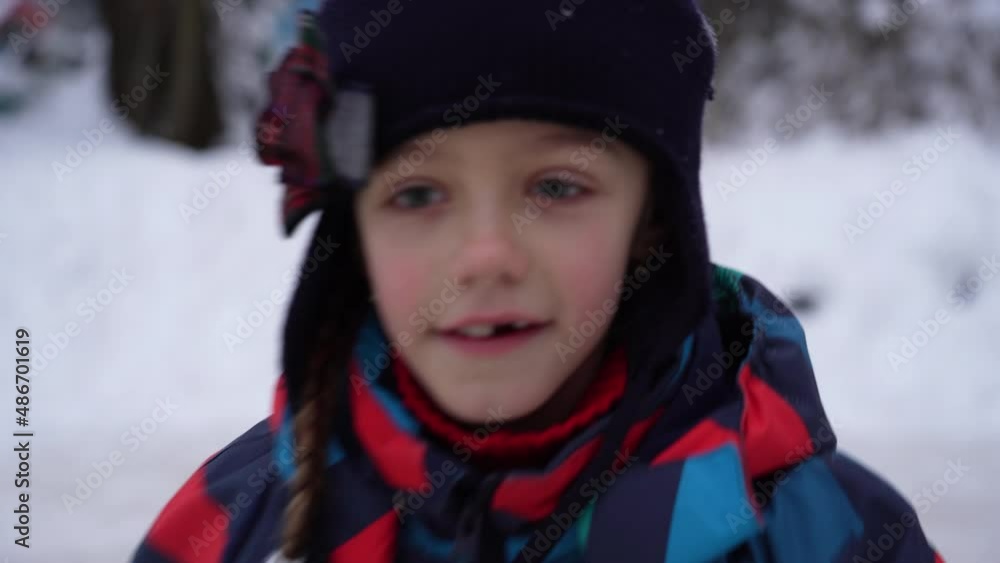 little girl carries out exercise on ice.  Little girl in overalls goes skating on camera on a frozen pond in the countryside in winter