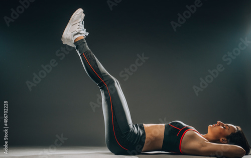 Attractive fitness woman preforming stretching exercise
