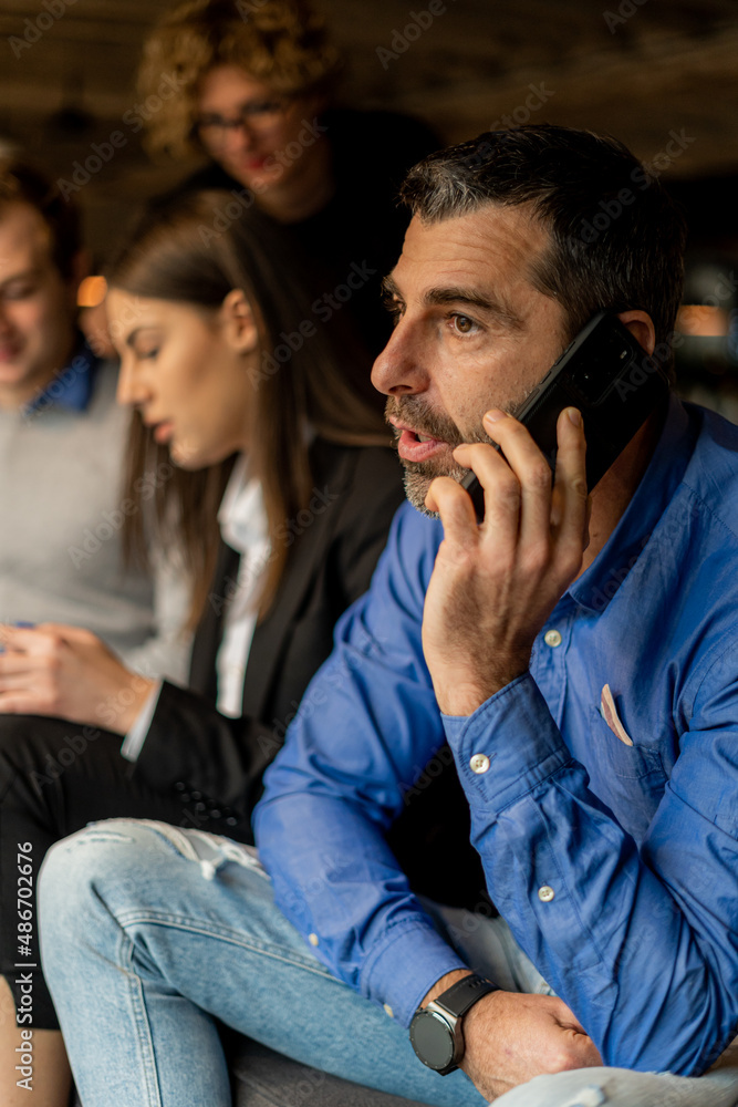 Fototapeta premium Talking on the phone with his boss
