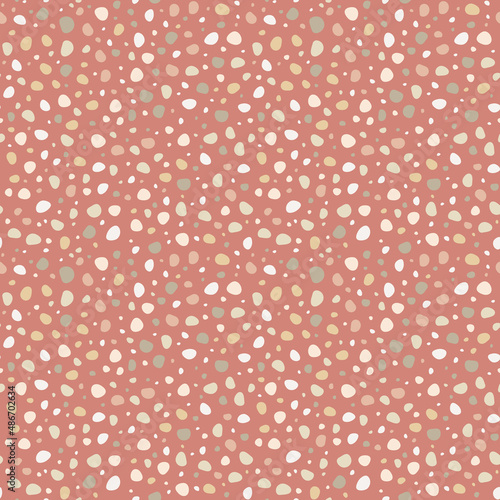 Doodle dots hand drawn, simple abstract seamless pattern in polka dot style. Smooth shapes in pastel palette on muted red background. Random spots design