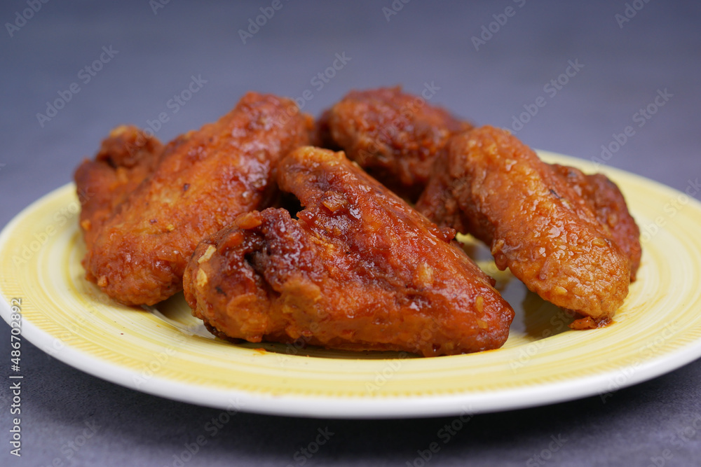 chicken wings on a plate on black background chicken wings on a plate on black background