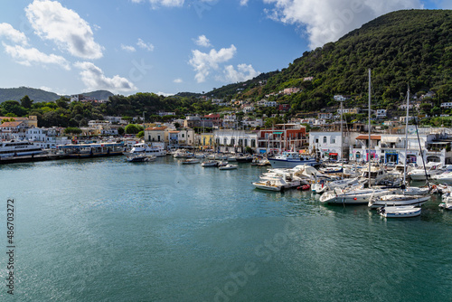 Fishing boats and yachts moored at Ischia Porto in beautiful sunny day, Campania region, Italy