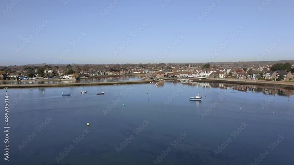 Aerial over boats and the calm water of Emsworth estuary and towards the Emsworth Mill Pond. Aerial over boats and the calm water of Emsworth estuary and towards the Emsworth Mill Pond.