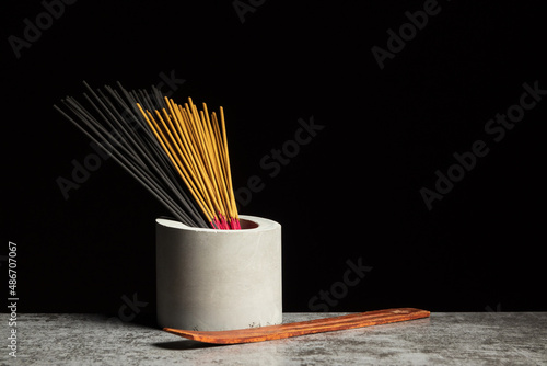 Many different aromatic incense sticks and wooden stand for them. Copy space photo