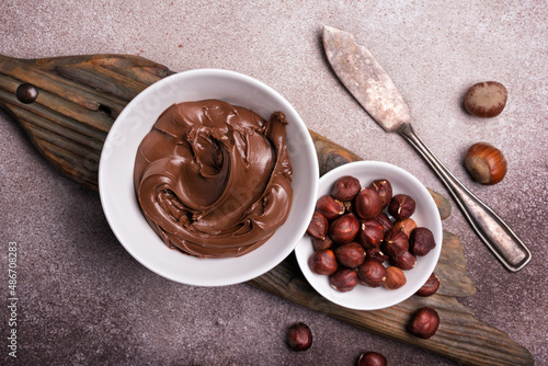 Tasty chocolate cream or sweet nut butter with whole hazelnuts