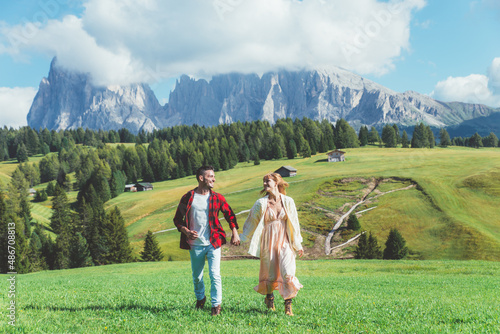Happy couple on vacation on the italian dolomites mountains. Concept about wanderlust travels and vacation