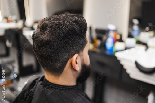 Stylish male client sitting in a barber shop