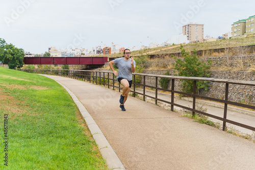 White man with long hair running in park. Sport Concept