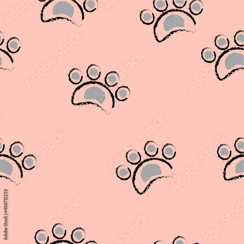 Black-gray dog ​​footprints on a light brown background. It is a seamless vector pattern work.