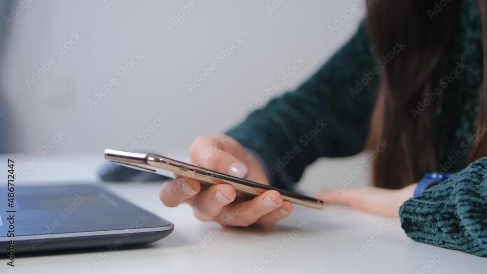 Woman browsing modern phone. Young female using new smartphone for communication at home. Freelancer person networking and communicating with clients on social media app in cellphone Woman browsing modern phone. Young female using new smartphone for communication at home. Freelancer person networking and communicating with clients on social media app in cellphone