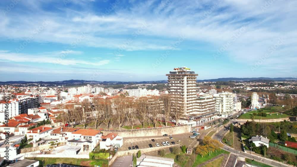 Santo Tirso, Portugal - January 1, 2022: DRONE AERIAL PAN FOOTAGE - Apartment buildings, The Pavilhão Desportivo Municipal (Municipal Sports Pavilion) 25th of April Square, and Santo Tirso City Hall. Santo Tirso, Portugal - January 1, 2022: DRONE AERIAL PAN FOOTAGE - Apartment buildings, The Pavilhão Desportivo Municipal (Municipal Sports Pavilion) 25th of April Square, and Santo Tirso City Hall.