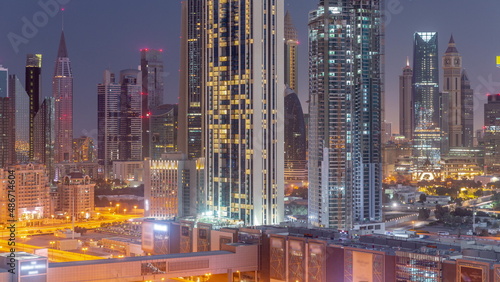 Panorama of the tall buildings around Sheikh Zayed Road and DIFC district aerial night to day timelapse in Dubai