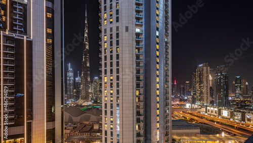 Cuadro en lienzo Tallest skyscrapers in downtown dubai located on bouleward street near shopping mall aerial night timelapse
