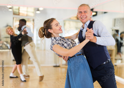 Man and woman learning to dance classical ballroom dance