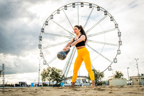 Sportive girl training on the beach - Fitness woman with sportswear doing functional training exercises outdoors