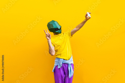 Foto Cool man wearing 3d origami mask - Funny creative portrait of cool character wit