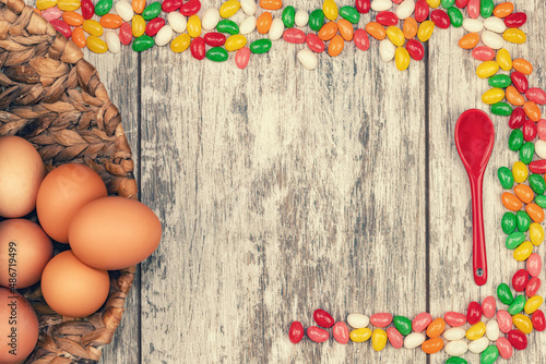 Easter background with eggs and colorful candies with space for text