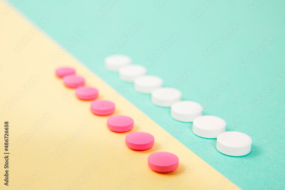 White and pink medicines on a colored background White and pink medicines on a colored background
