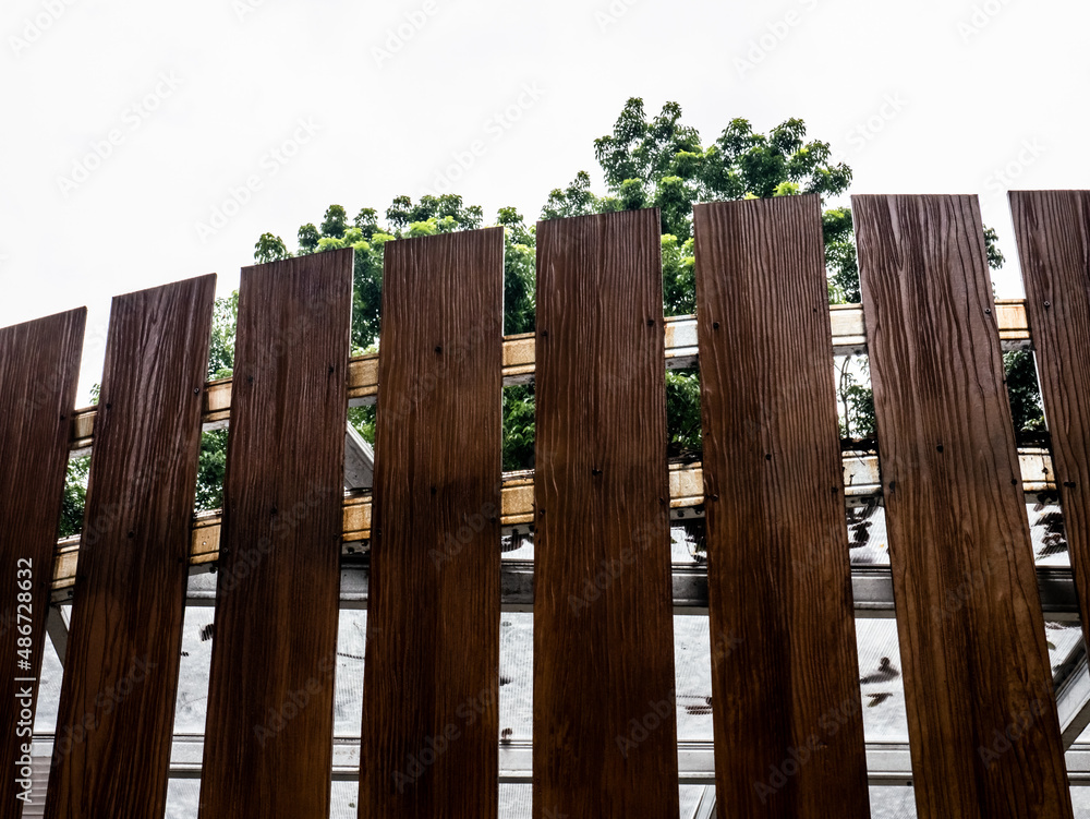 brown minimalist wooden fence with white sky background
