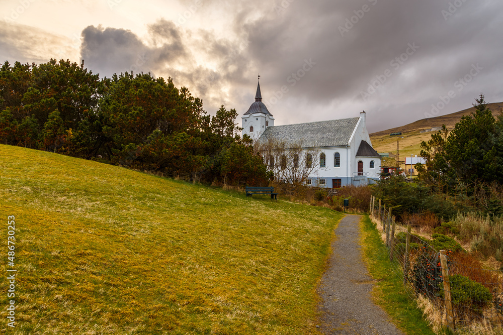 View of the Midvagur Church in small village on Vagar island. Leitisvegur, Sandavagur, Faroe Islands. View of the Midvagur Church in small village on Vagar island. Leitisvegur, Sandavagur, Faroe Islands.