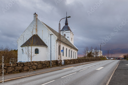 View of the Midvagur Church in small village on Vagar island. Leitisvegur, Sandavagur, Faroe Islands. photo