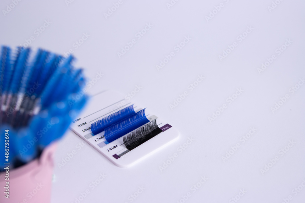 Artificial eyelashes in black and blue on a white background