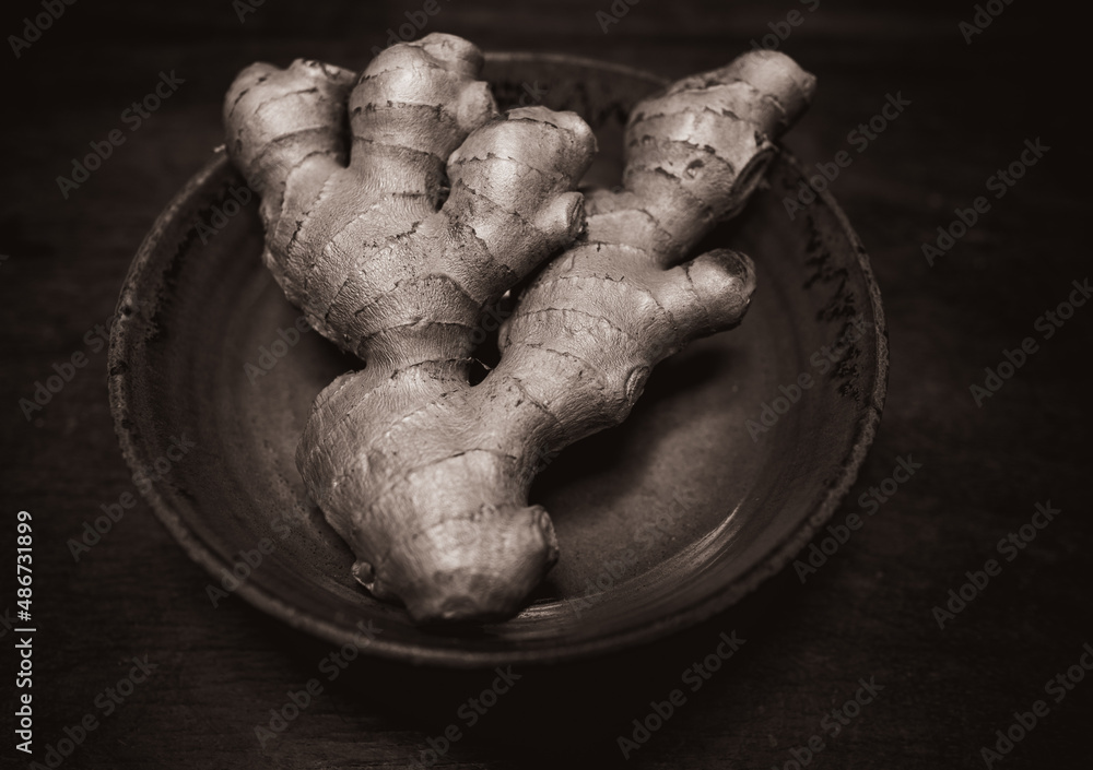 Ginger in bowl on wooden table Ginger in bowl on wooden table