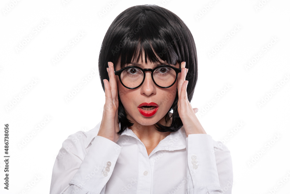 Black haired woman with red lips wearing white shirt showing emotions of bewilderment or surprise. Black haired woman with red lips wearing white shirt showing emotions of bewilderment or surprise.