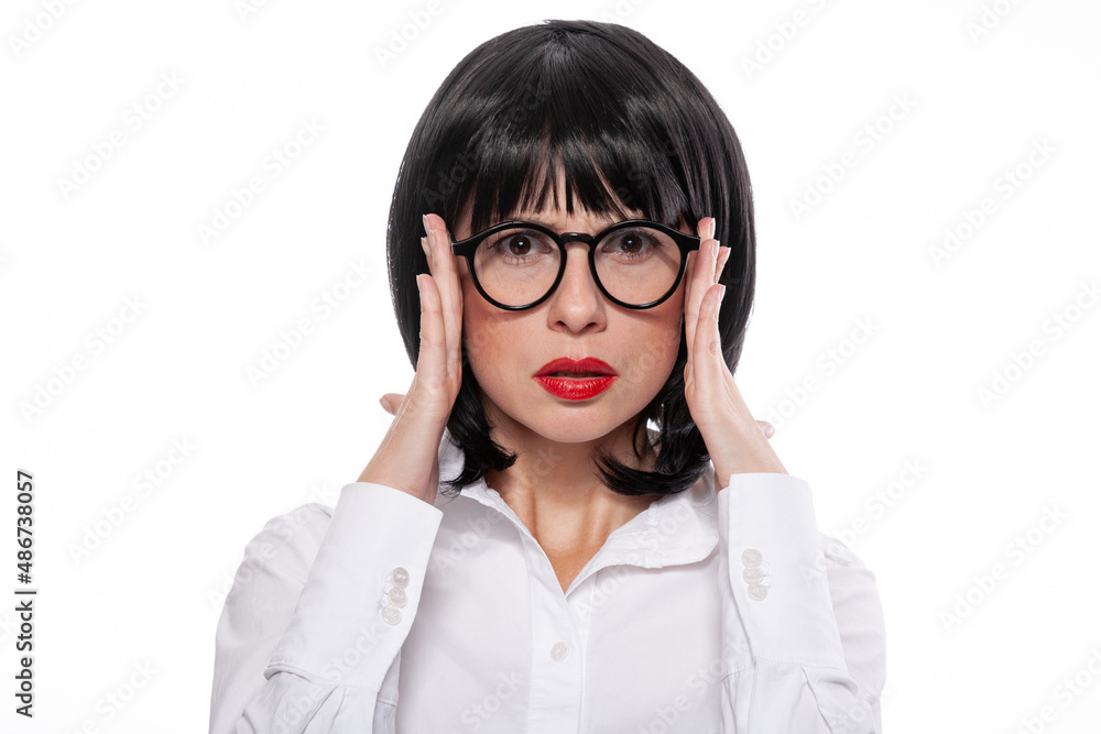 Black haired woman with red lips wearing white shirt showing emotions of mental concentration Black haired woman with red lips wearing white shirt showing emotions of mental concentration