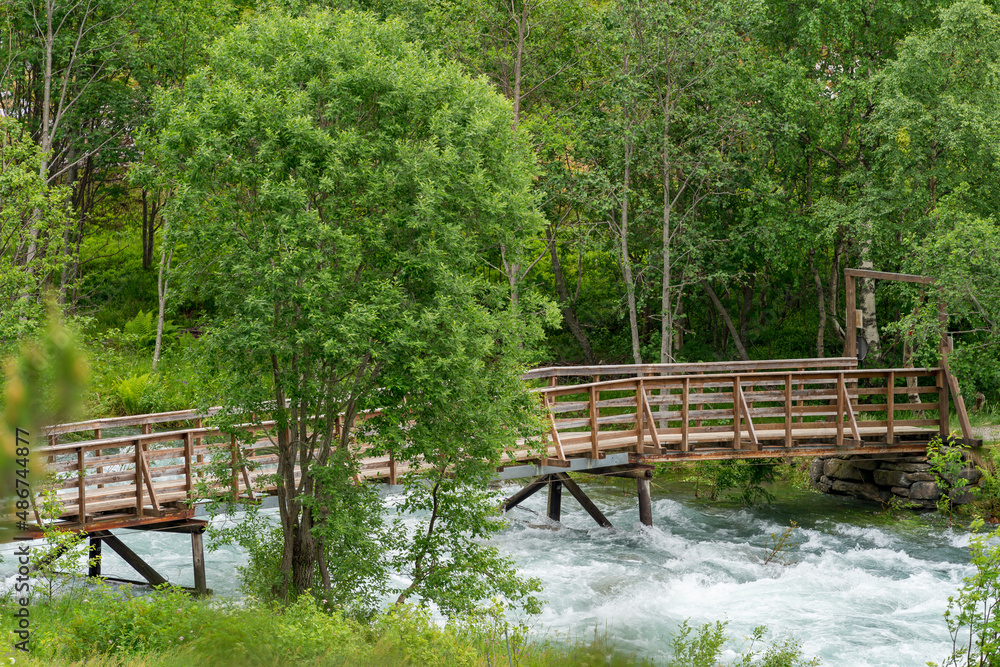 Bridge over the river at Muldalsfossen waterfall in Norway. Bridge over the river at Muldalsfossen waterfall in Norway.