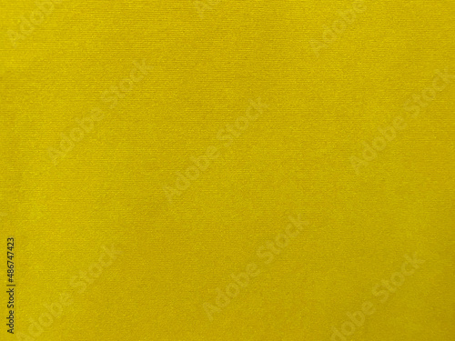 Yellow velvet fabric texture used as background. Empty yellow fabric background of soft and smooth textile material. There is space for text....