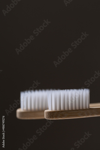 Set of ECO friendly wooden bamboo toothbrushes. Save the planet or NO plastic concept. Isolated on grey background.