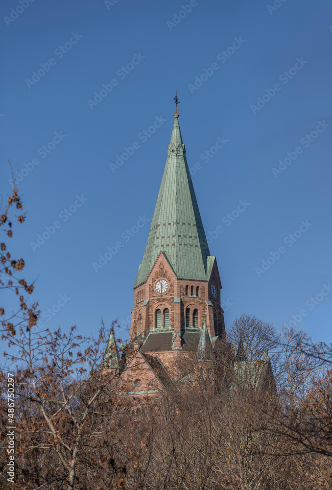 The tower of the church Sofia Kyrka on hill in the park Vitabergsparken in the district Södermalm a sunny winter day in Stockholm