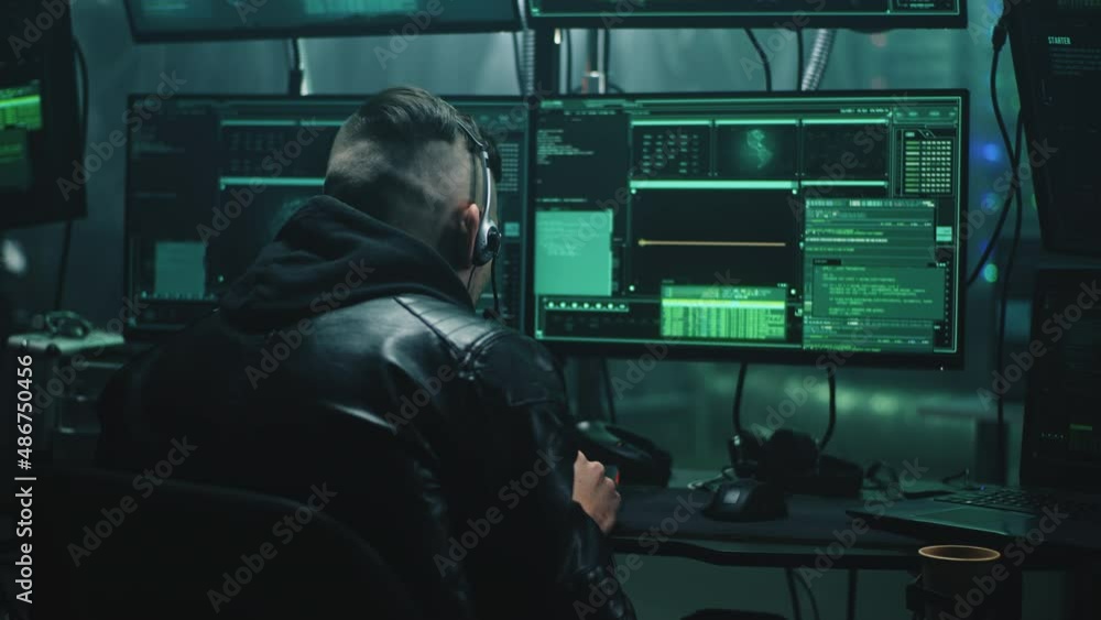Hacker with headset changing his voice using software and introducing himself as a bank employee, stealing private data and money from credit card from victim by making call from base with computers Hacker with headset changing his voice using software and introducing himself as a bank employee, stealing private data and money from credit card from victim by making call from base with computers