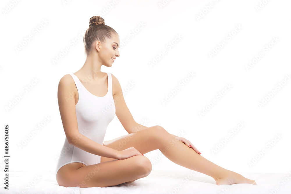 Young, fit and beautiful brunette woman in white swimsuit posing over white background. Healthcare, diet, sport and fitness. Young, fit and beautiful brunette woman in white swimsuit posing over white background. Healthcare, diet, sport and fitness.