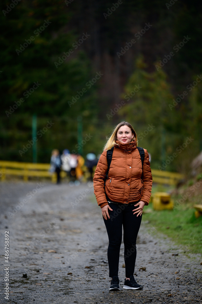 Tourist in the Carpathians, a girl on a background of mountains in the rehabilitation center of brown bears, Synevyr glade. Tourist in the Carpathians, a girl on a background of mountains in the rehabilitation center of brown bears, Synevyr glade.