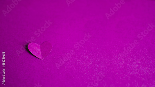 Banner with single purple paper heart on purple background. Happy Valentine Day. Greeting card. DIY Holiday and gift concept. Copy space