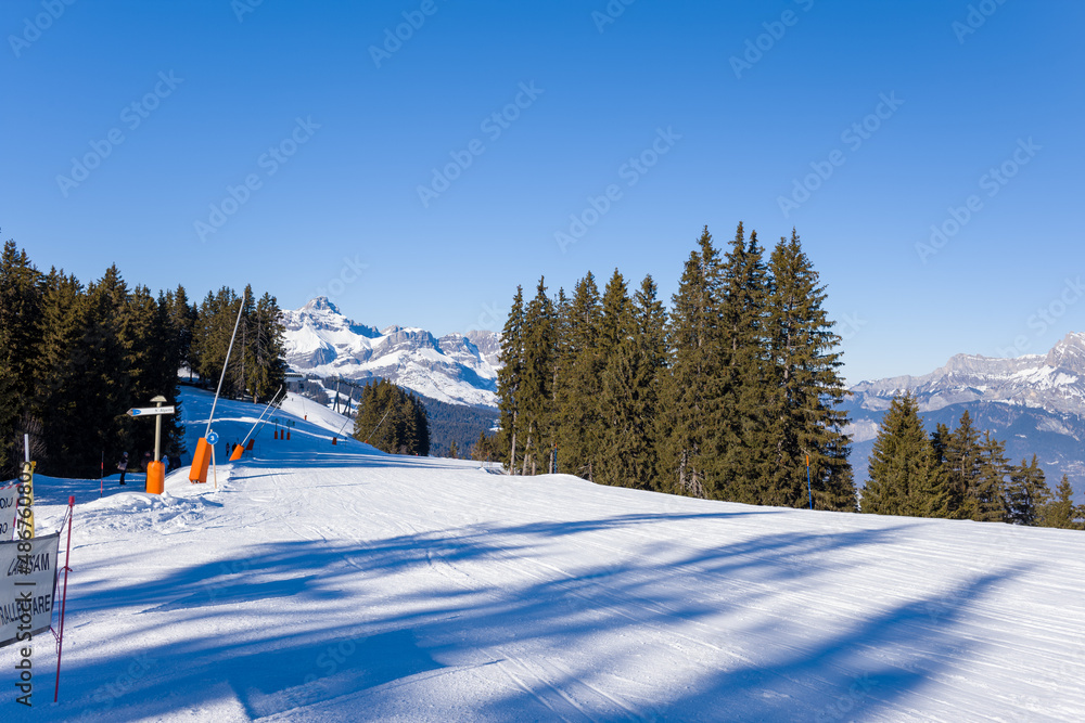 A Megeve ski slope in the middle of the mountains of the Mont Blanc massif in Europe, France, Rhone Alpes, Savoie, Alps, in winter, on a sunny day. A Megeve ski slope in the middle of the mountains of the Mont Blanc massif in Europe, France, Rhone Alpes, Savoie, Alps, in winter, on a sunny day.