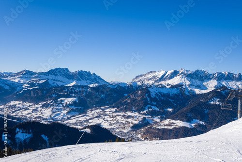 The city of Megeve in the valley in the middle of the mountains of the Mont Blanc massif in Europe, France, Rhone Alpes, Savoie, Alps, in winter, on a sunny day.
