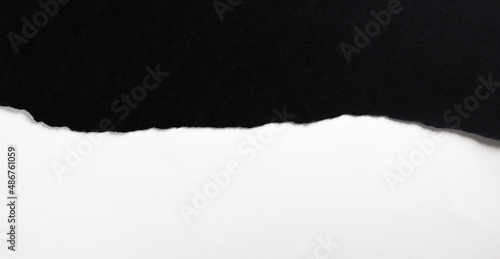 Black paper with torn edges isolated with white colored paper background inside. Good paper texture 