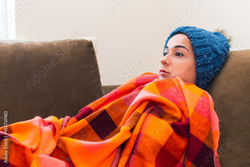 Bild auf Leinwand a woman with a plaid and a hat is sick at home. bed rest.