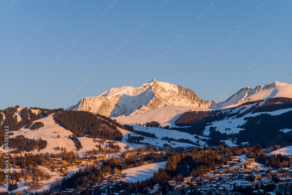 Mont Blanc massif and Megeve at sunset in Europe, France, Rhone Alpes, Savoie, Alps, in winter, on a sunny day.