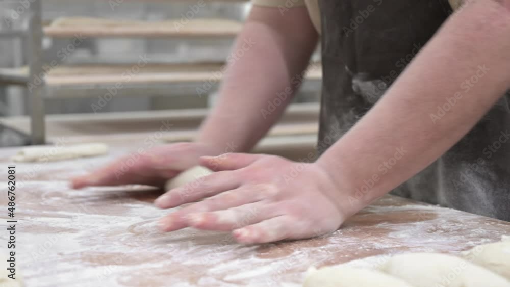 Baker kneading dough in a bakery. High quality 4k footage Baker kneading dough in a bakery. High quality 4k footage