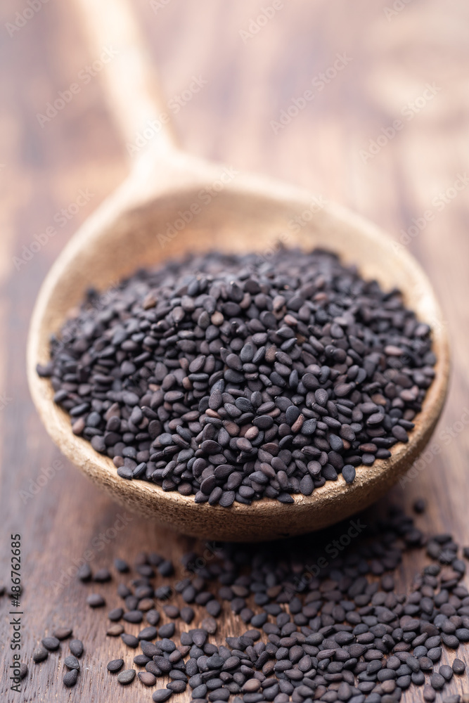 Bio natural black sesame seeds on wooden spoon. Bio natural black sesame seeds on wooden spoon.