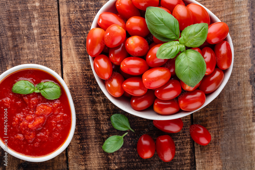 Fresh tomatoes in bowl on old wooden table. Fresh tomatoes in bowl on old wooden table.