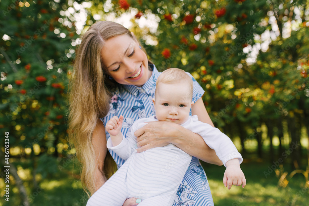 Happy mother playing with her baby in her arms smiling Happy mother playing with her baby in her arms smiling